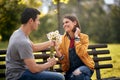 Man giving bouquet of flowers to a woman; Happy couple concept