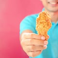 A man giving fried chicken leg or drumstick Royalty Free Stock Photo