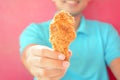 A man giving fried chicken leg or drumstick Royalty Free Stock Photo