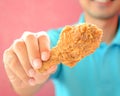 A man giving fried chicken leg or drumstick Royalty Free Stock Photo