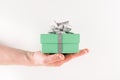Man giving Gift Box, Man holding a Pastel Green gift box with Silver ribbon and bow on white background Royalty Free Stock Photo