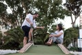 Man giving golf lesson to a woman
