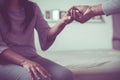 Man giving hand to depressed woman,Psychiatrist holding hands patient,Mental health care concep