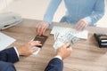 Man giving money to teller at cash department window Royalty Free Stock Photo