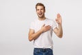 Man giving oath, swear telling truth or be honest. Happy confident and charismatic blond handsome man in white t-shirt