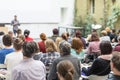 Man giving presentation in lecture hall at university. Royalty Free Stock Photo