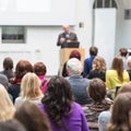 Man giving presentation in lecture hall at university.