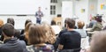 Man giving presentation in lecture hall at university. Royalty Free Stock Photo