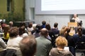 Man giving presentation in lecture hall at university. Royalty Free Stock Photo