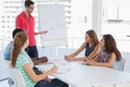 Man giving presentation to casual team in office