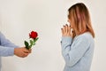 Man giving a red rose and surprised woman. Valentine card concept. Royalty Free Stock Photo