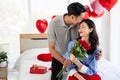 Man giving a rose and a kiss to his beautiful wife in bed Valentine`s Day  concept Royalty Free Stock Photo