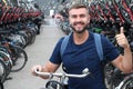 Man giving thumbs up in bicycle parking lot Royalty Free Stock Photo