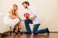 Man giving unhappy woman candy bunch flowers. Royalty Free Stock Photo