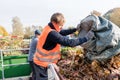 Man giving waste green in container on recycling center Royalty Free Stock Photo
