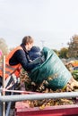 Man giving waste green in container on recycling center Royalty Free Stock Photo
