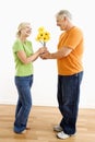 Man giving woman bouquet.