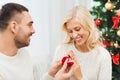 Man giving woman engagement ring for christmas Royalty Free Stock Photo