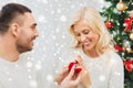 Man giving woman engagement ring for christmas Royalty Free Stock Photo