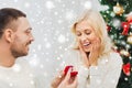 Man giving woman engagement ring for christmas Royalty Free Stock Photo