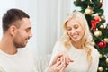 Man giving woman engagement ring for christmas Royalty Free Stock Photo