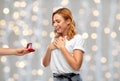 Man giving woman engagement ring over lights Royalty Free Stock Photo