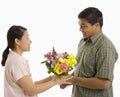 Man giving woman flowers.