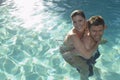 Man Giving Woman Piggyback In Swimming Pool Royalty Free Stock Photo