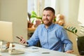 A man glad to hear his colleagues on an online briefing in his apartment Royalty Free Stock Photo