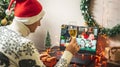 Man with a glass of champagne is remotely communicating with friends and family via video link. Concept of party online