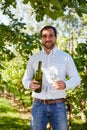 Man with a glass of white wine in the vineyard Royalty Free Stock Photo