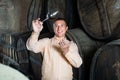 Man with glass of wine in winery cellar. Royalty Free Stock Photo