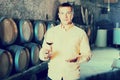 Man with glass of wine in winery cellar Royalty Free Stock Photo