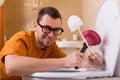 Man in glasses cleaning the toilet bowl