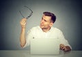 Man with glasses having eyesight problems confused with laptop Royalty Free Stock Photo