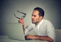 Man with glasses having eyesight problems confused with laptop Royalty Free Stock Photo