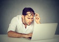 Man with glasses having eyesight problems confused with laptop Royalty Free Stock Photo