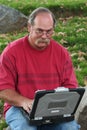 Man with glasses on laptop