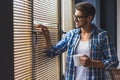 Man in glasses looking thru jalousie Royalty Free Stock Photo