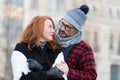 Guy in looks to woman face. Husband embraces wife on street. Urban family on street look into eyes. Sweet emotion