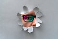 Man in glasses peeping through hole on paper Royalty Free Stock Photo