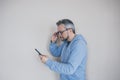 man with glasses with presbyopia looking at the phone