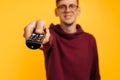 Remote controlled man. cheerful man holding a remote control in his hand and looking at the camera Royalty Free Stock Photo