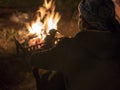 Man in Glasses Near the Bonfire at Night in Old Cave City Uchisar Castle in Cappadocia. Royalty Free Stock Photo