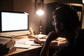 Man in glasses sitting and using computer for studying Royalty Free Stock Photo