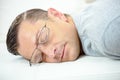 Man with glasses sleeping on desk Royalty Free Stock Photo