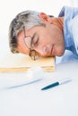 Man with glasses sleeping on his files Royalty Free Stock Photo