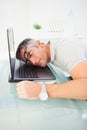 Man with glasses sleeping on his laptop Royalty Free Stock Photo