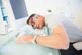 Man with glasses sleeping on the keyboard Royalty Free Stock Photo