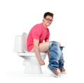 Man with glasses straining on the toilet